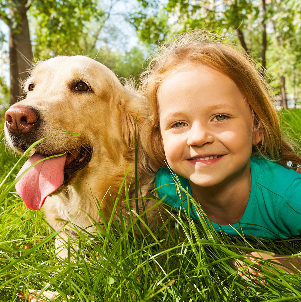 girl laying by dog